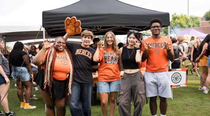 3 things to know about Mercer vs. Western Carolina football game day: Oct. 10, 2026 Five students in Mercer University gear making bear claw hand gestures in front of a tent.