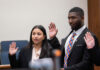 From adoptee to advocate: Law student honored for commitment to access to justice A woman and a man in professional attire stand with their right hands raised to take an oath.
