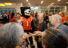 Countdown to 19 continues with University-wide, community events A Mercer University bear mascot stands in a crowded room with people, including the Mercer president, holding small ice cream cups.