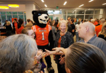 Countdown to 19 continues with University-wide, community events A Mercer University bear mascot stands in a crowded room with people, including the Mercer president, holding small ice cream cups.