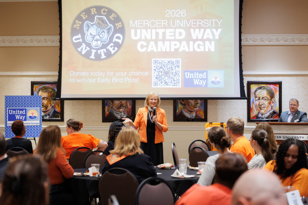 President Penny L. Elkins, Ph.D., speaks at a podium in front of a projection screen for the 2026 Mercer University United Way campaign.