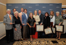 11th annual alumni awards recognize outstanding Mercerians Group of ten people standing in front of a Mercer University backdrop, holding awards and certificates.