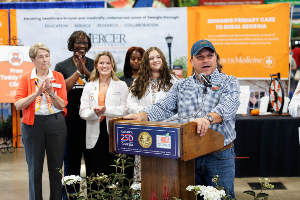 Georgia Agriculture Commissioner Tyler J. Harper speaks at a wooden podium.