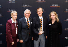 Ed Grimsley, M.D., named 2026 Sandra Dunagan Deal Rural Service Fellow Mercer School of Medicine Dean Jean Sumner, M.D.; former Gov. Nathan Deal; Ed Grimsley, M.D.; and Mercer Vice President of External Relations Ember Bentley standing in front of a Mercer University School of Medicine backdrop.