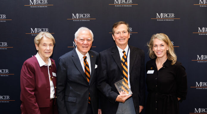 Ed Grimsley, M.D., named 2026 Sandra Dunagan Deal Rural Service Fellow Mercer School of Medicine Dean Jean Sumner, M.D.; former Gov. Nathan Deal; Ed Grimsley, M.D.; and Mercer Vice President of External Relations Ember Bentley standing in front of a Mercer University School of Medicine backdrop.