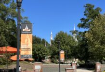 Board of Trustees elects new Trustees, officers; celebrates student success Mercer University campus walkway with banners reading United in Mission. Amplified for Impact.