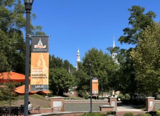 Board of Trustees elects new Trustees, officers; celebrates student success Mercer University campus walkway with banners reading United in Mission. Amplified for Impact.
