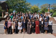 Mercer welcomes 15th class of Stamps Scholars A large group of students in formal attire standing on outdoor stairs for a portrait.