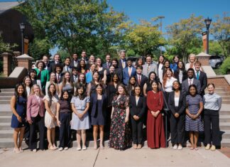 Mercer welcomes 15th class of Stamps Scholars A large group of students in formal attire standing on outdoor stairs for a portrait.