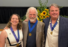 Mercerians honored with Cultural Arts Awards from Macon Arts Alliance Three people wearing blue ribbons with gold medals pose for a photo in front of a sunflower arrangement.