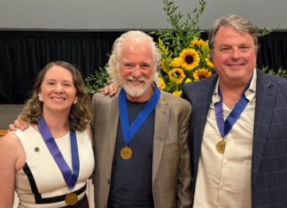 Mercerians honored with Cultural Arts Awards from Macon Arts Alliance Three people wearing blue ribbons with gold medals pose for a photo in front of a sunflower arrangement.