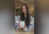 Junior selected for $5,000 Women in Transportation scholarship A woman with long wavy hair wearing a striped sweater smiles while holding a white mug at a cafe table.