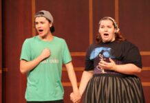 Mercer Opera brings classic novel to life in latest production A young man and woman holding hands while singing on a stage.